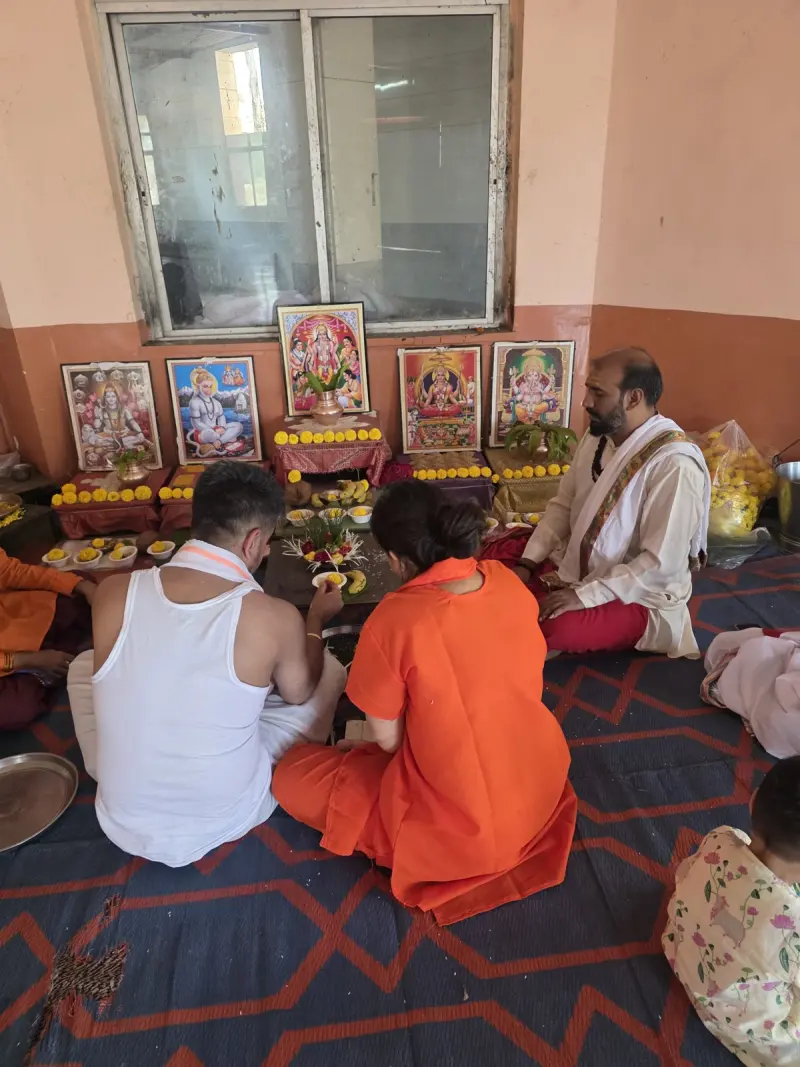 Parents and children seated for their family puja