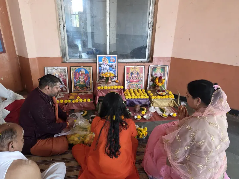 A family's puja in progress with the pandit