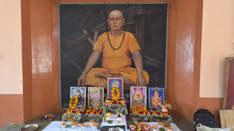 The shrine in the puja hall with the Guru's portrait and the deities
