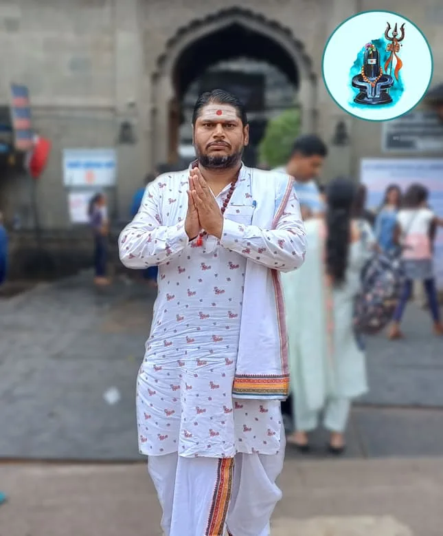 Pandit Rakesh Shukla Guruji standing in namaste at the Trimbakeshwar temple gate